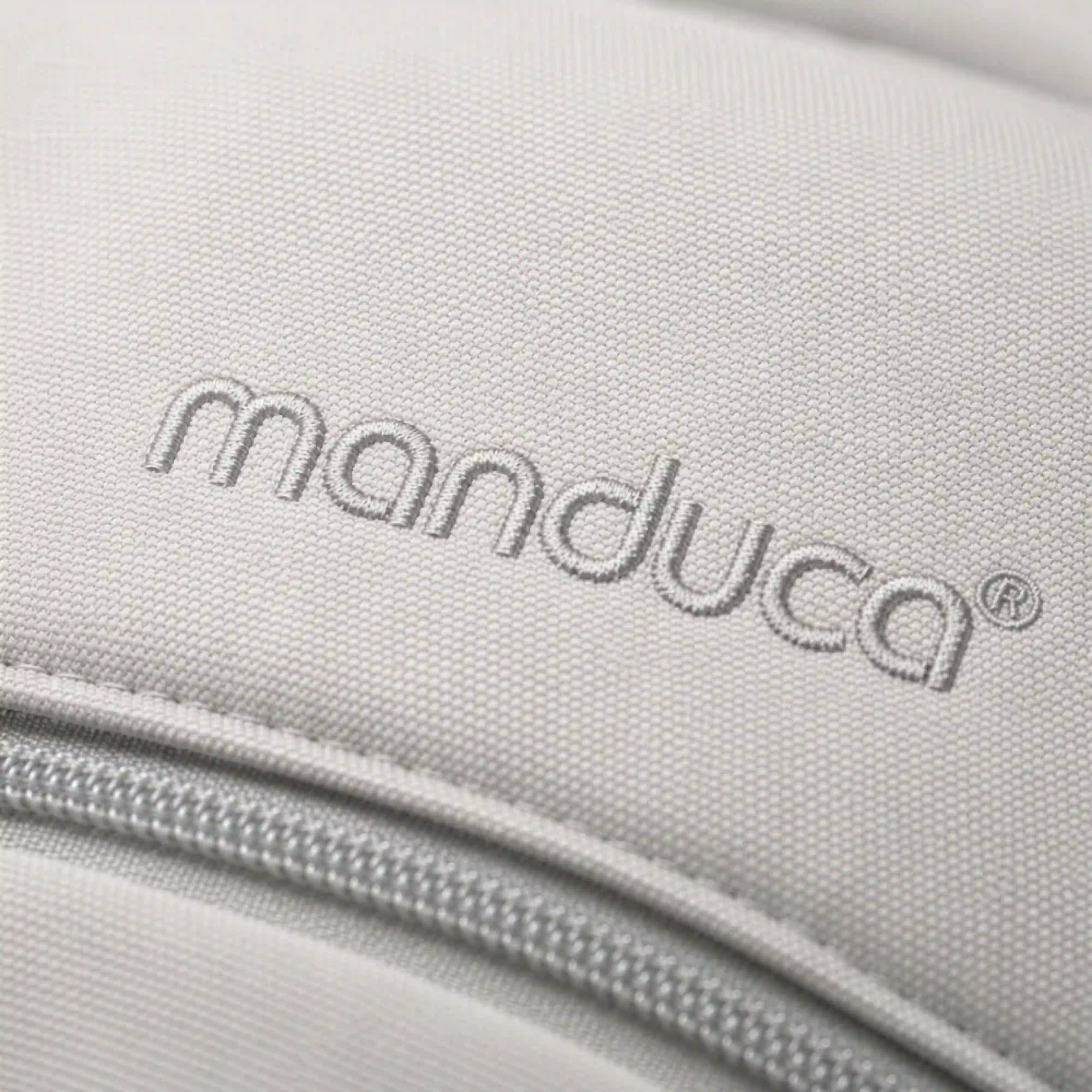 Ein Close up des Schriftzuges manduca von der manduca XT Babytrage in monochrome Cloud